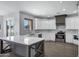 Bright kitchen with white cabinets, quartz countertops, stainless steel appliances, and a gray kitchen island at 24615 S 182Nd Pl, Gilbert, AZ 85298