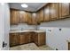 Practical laundry room boasting ample dark wood cabinetry and counter space at 24615 S 182Nd Pl, Gilbert, AZ 85298
