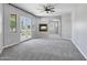 Large living room featuring a fireplace, ceiling fan, and French doors with plenty of natural light at 24615 S 182Nd Pl, Gilbert, AZ 85298
