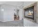 Cozy living room with stone fireplace, leading to an archway with a bathroom and tub at 24615 S 182Nd Pl, Gilbert, AZ 85298