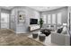 Open living room featuring stone floors, modern furniture, and plenty of natural light at 24615 S 182Nd Pl, Gilbert, AZ 85298
