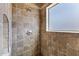 Shower featuring beige tile and a window for natural light at 24615 S 182Nd Pl, Gilbert, AZ 85298