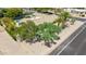This aerial view shows a private backyard pool framed by mature trees and meticulous desert landscaping at 28 E Winged Foot Rd, Phoenix, AZ 85022