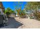 Landscaped backyard featuring decorative rock, stone walkway and a trellis at 28 E Winged Foot Rd, Phoenix, AZ 85022