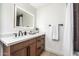 Stylish bathroom featuring modern vanity with wooden cabinets, sleek black fixtures, and backlit mirror at 28 E Winged Foot Rd, Phoenix, AZ 85022