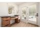 Stylish bathroom vanity area with a large mirror and outdoor access to the pool area at 28 E Winged Foot Rd, Phoenix, AZ 85022