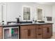 Bathroom vanity featuring a beverage cooler, double sinks, and modern fixtures at 28 E Winged Foot Rd, Phoenix, AZ 85022