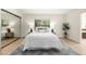 Bright bedroom with a neutral color palette, a large window and a mirrored closet at 28 E Winged Foot Rd, Phoenix, AZ 85022