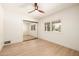 Bright bedroom with a ceiling fan, a large window and a mirrored closet at 28 E Winged Foot Rd, Phoenix, AZ 85022