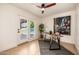 Inviting office space with stylish desk, backyard access, and an inspiring art piece at 28 E Winged Foot Rd, Phoenix, AZ 85022