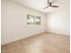 Light-filled bedroom featuring modern shutters, hardwood floors, and a ceiling fan at 28 E Winged Foot Rd, Phoenix, AZ 85022
