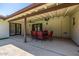 Comfortable covered patio with ceiling fans, with an elegant table and chairs for outdoor enjoyment at 28 E Winged Foot Rd, Phoenix, AZ 85022