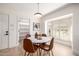 Bright dining area features a round table, modern light fixture and shuttered window at 28 E Winged Foot Rd, Phoenix, AZ 85022