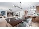 Dining room with modern lighting, seating for six, and views of the living spaces at 28 E Winged Foot Rd, Phoenix, AZ 85022