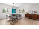 Dining room with modern chandelier, unique artwork, and seating for six at 28 E Winged Foot Rd, Phoenix, AZ 85022