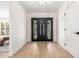 Bright entryway features a black double door, light hardwood floors, and recessed lighting at 28 E Winged Foot Rd, Phoenix, AZ 85022