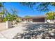 A single-story home with desert landscaping, a paved driveway, and a two-car brown garage door at 28 E Winged Foot Rd, Phoenix, AZ 85022