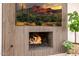 Living room fireplace with wood accent wall and flatscreen TV at 28 E Winged Foot Rd, Phoenix, AZ 85022