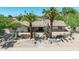 Home exterior featuring a stone facade, tiled roof, desert landscaping, and palm trees at 28 E Winged Foot Rd, Phoenix, AZ 85022