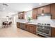 Bright kitchen boasts stainless steel appliances, quartz countertops, and wooden cabinetry at 28 E Winged Foot Rd, Phoenix, AZ 85022