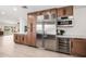 Gourmet kitchen boasts stainless steel appliances, wine fridge, and custom wood cabinetry at 28 E Winged Foot Rd, Phoenix, AZ 85022