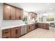 Bright kitchen boasts stainless steel appliances, quartz countertops, and wooden cabinetry at 28 E Winged Foot Rd, Phoenix, AZ 85022