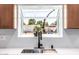 Bright kitchen features a stainless steel sink, black faucet and garden view at 28 E Winged Foot Rd, Phoenix, AZ 85022