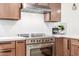 Modern kitchen with stainless steel appliances and sleek white countertops at 28 E Winged Foot Rd, Phoenix, AZ 85022