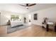 Spacious main bedroom with a ceiling fan, a large window and an elegant sitting area at 28 E Winged Foot Rd, Phoenix, AZ 85022
