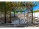 Backyard trellis with overgrown vines in a desert landscaped yard at 28 E Winged Foot Rd, Phoenix, AZ 85022