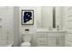 Modern bathroom featuring a white vanity, framed art, and a shower-tub combination at 3006 E Lucky Horseshoe Ln, San Tan Valley, AZ 85140