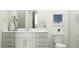 Bright bathroom with white vanity, framed mirror, and toilet next to a glass-enclosed shower at 3006 E Lucky Horseshoe Ln, San Tan Valley, AZ 85140