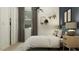 A well-lit bedroom with a closet, cozy bedding and bedside tables with matching lamps at 3006 E Lucky Horseshoe Ln, San Tan Valley, AZ 85140