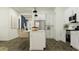 Bright, modern kitchen with white cabinets, stainless steel appliances, and a spacious island with seating at 3006 E Lucky Horseshoe Ln, San Tan Valley, AZ 85140
