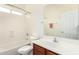 Bathroom features a tub-shower combination, toilet, and a sink with a mirror at 3085 E Camellia Dr, Gilbert, AZ 85296