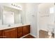 Bathroom featuring a double sink vanity with wood cabinets and shower at 3085 E Camellia Dr, Gilbert, AZ 85296