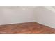 Empty room with hardwood floors, base trim, and neutral walls ready for your personal touch at 3085 E Camellia Dr, Gilbert, AZ 85296