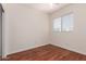 Bright bedroom with wood floors, a window, and a ceiling fan at 3085 E Camellia Dr, Gilbert, AZ 85296