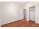 Bedroom with wood floor, walk-in closet, and an open doorway to another room at 3085 E Camellia Dr, Gilbert, AZ 85296