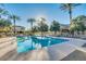 Resort-style community pool surrounded by lounge chairs and palm trees under a bright blue sky at 3085 E Camellia Dr, Gilbert, AZ 85296