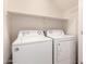 Laundry room features a white washer and dryer with white shelving above at 3085 E Camellia Dr, Gilbert, AZ 85296