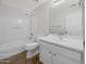 Bathroom features a shower-tub combo and a white vanity with a sink and a mirror at 31670 N Desert Willow Rd, San Tan Valley, AZ 85143