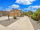 Home featuring a large driveway and attached three-car garage at 31670 N Desert Willow Rd, San Tan Valley, AZ 85143