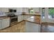 Bright kitchen with stainless steel appliances, stone countertops, and ample counter space at 31670 N Desert Willow Rd, San Tan Valley, AZ 85143