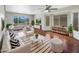 Bright living room featuring hardwood floors, neutral paint, stylish furniture, and lots of natural light at 31670 N Desert Willow Rd, San Tan Valley, AZ 85143