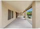 Covered patio features concrete floors and ceiling fan, overlooking the backyard at 31670 N Desert Willow Rd, San Tan Valley, AZ 85143