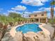 Backyard featuring an in-ground pool, rock features and mature landscaping at 31670 N Desert Willow Rd, San Tan Valley, AZ 85143