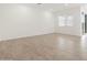 Well-lit living room featuring large windows and tile flooring at 3529 E Audrey Dr, San Tan Valley, AZ 85143
