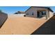 Large, blank canvas backyard awaiting your custom design with block wall providing privacy at 3557 E Audrey Dr, San Tan Valley, AZ 85143