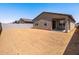 A large backyard area with a covered patio and block fence, ready for landscaping at 3557 E Audrey Dr, San Tan Valley, AZ 85143